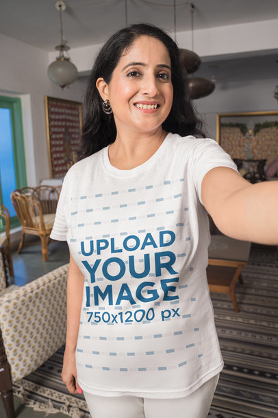 T-Shirt Mockup of an Adult Woman Taking a Selfie at Home