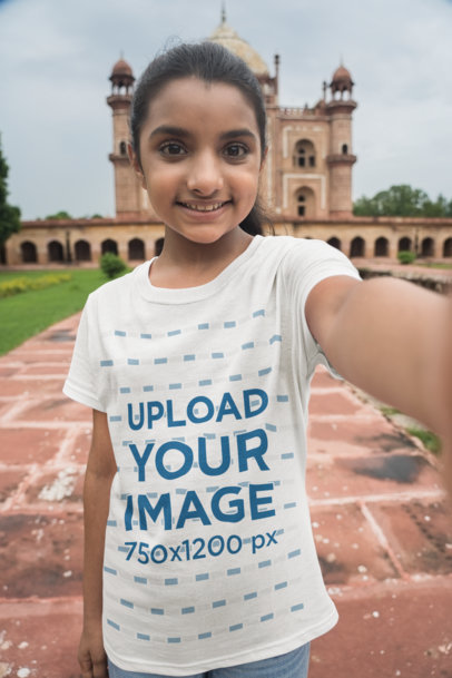 Mockup of a Cheerful Girl Wearing a T-Shirt While Taking a Selfie 