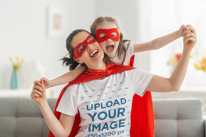 T-Shirt Mockup of a Mom and Daughter Wearing Hero Capes and Masks