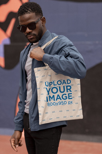 Mockup of a Man With Sunglasses Carrying a Tote Bag