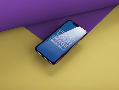 iPhone X Mockup Under a Light About to Drop from a Paper a20010