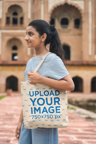 Mockup of a Girl Holding a Tote Bag 