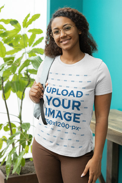 Mockup of a Woman Wearing a Bella Canvas T-Shirt and Carrying a Backpack