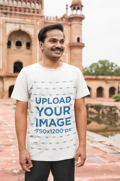 Mockup of a Happy Man Wearing a Tee Near an Ancient Temple 