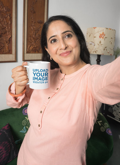 Mockup of a Happy Woman Holding a Mug While Taking a Selfie
