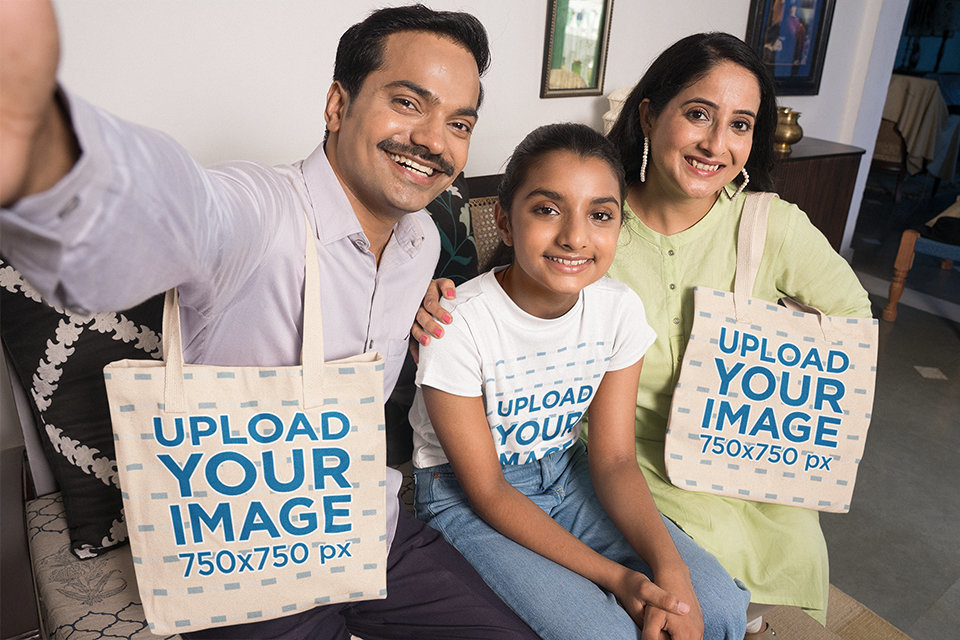 T-Shirt Mockup of a Family Holding Tote Bags and Taking a Selfie