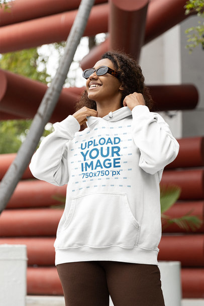Mockup of a Happy Woman Wearing a Pullover Hoodie and Sunglasses