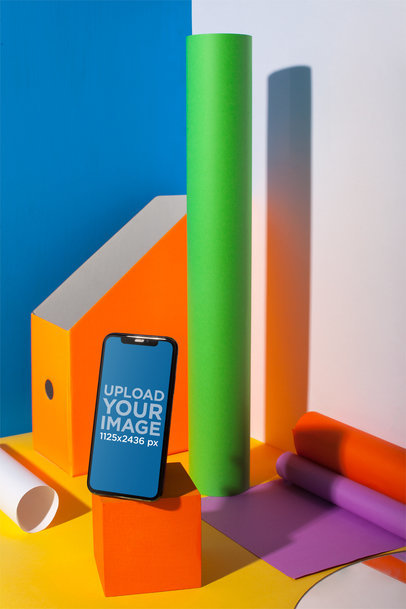 Portrait of an iPhone 11 Pro Mockup Standing on a Colorful Desk