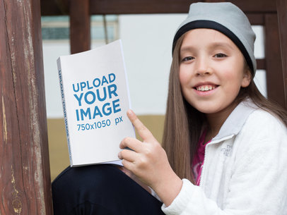 Smiling Girl Holding a Book Mockup at the Park