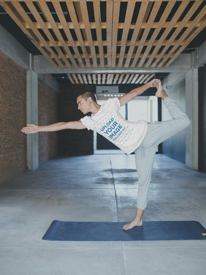 Man Wearing a T-Shirt Mockup Doing a Standing Bow Pulling Pose a19963