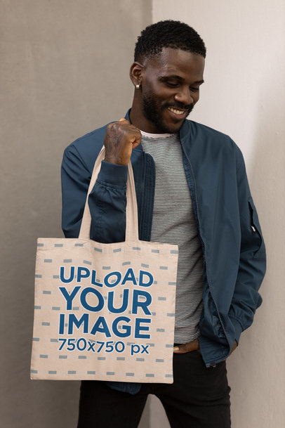 Mockup of a Bearded Man with an Earring Holding a Tote Bag