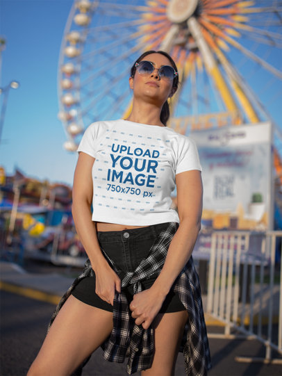 Portrait of a Woman Wearing a Crop Top Tee Mockup at an Amusement Park