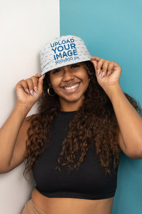 Mockup of a Smiling Woman With Long Hair Wearing a Bucket Hat 