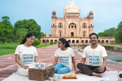 T-Shirt Mockup of a Family Having a Picnic With Tea Mugs by an Indian Temple