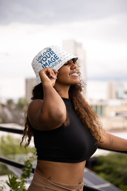 Bucket Hat Mockup Featuring a Happy Woman Posing in a Balcony