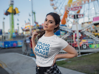 Beautiful Woman Wearing a T-Shirt Mockup at an Amusement Park