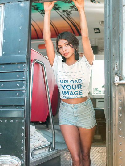 Latina Woman Wearing a Tshirt Mockup Holding to a Bus Door