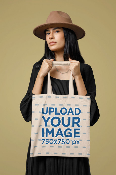 Mockup of a Serious Woman Carrying a Sublimated Tote Bag