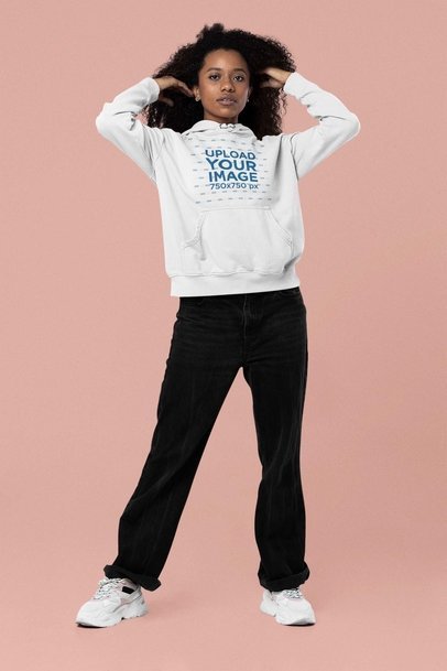 Mockup of a Woman with Curly Hair Posing in a Pullover Hoodie at a Studio