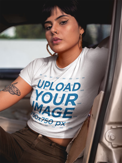 Woman Wearing a T-Shirt Mockup Sitting on a Car's Driver's Seat
