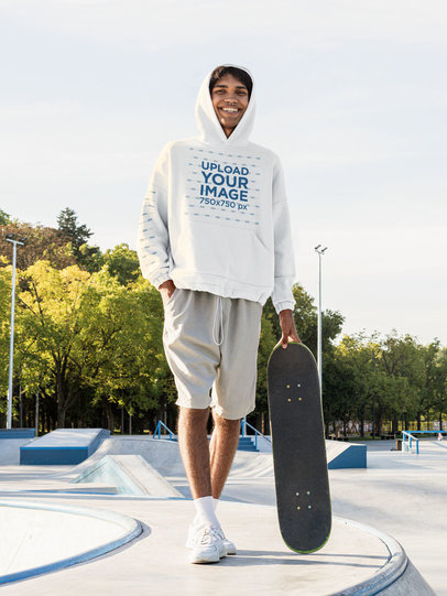Pullover Hoodie Mockup of a Smiling Man Holding a Skateboard