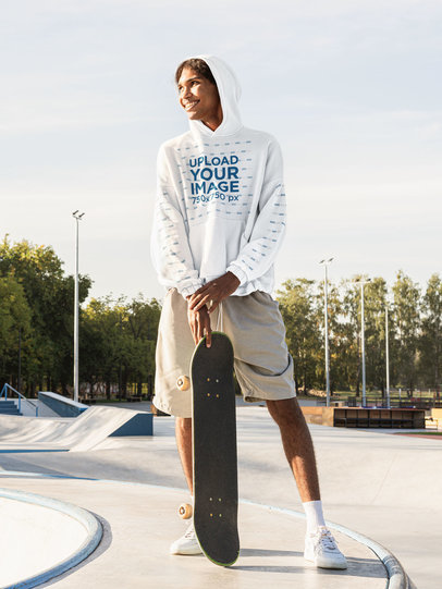 Mockup of a Man in a Pullover Hoodie Posing at a Skate Park