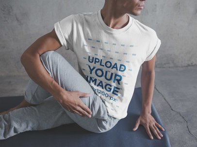 Man Stretching his Legs for the Yoga Class Wearing a T-Shirt Mockup