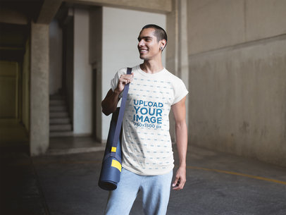 Happy Man Carrying a Yoga Mat Wearing a T-Shirt Mockup