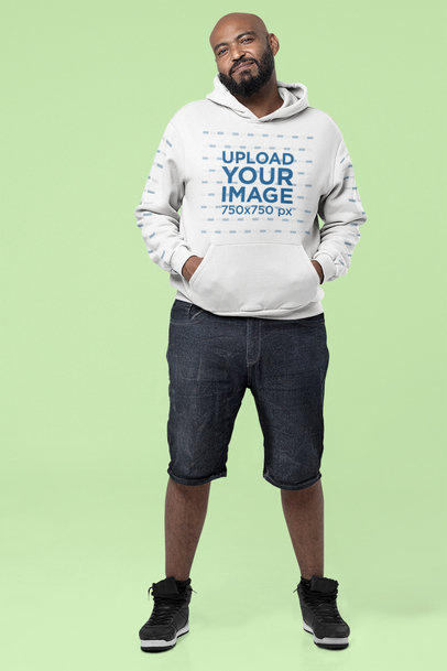 Mockup of a Bearded Man with a Hoodie Posing in a Studio