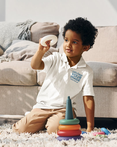 Polo Shirt Mockup of a Little Kid Playing with Toys in a Living Room