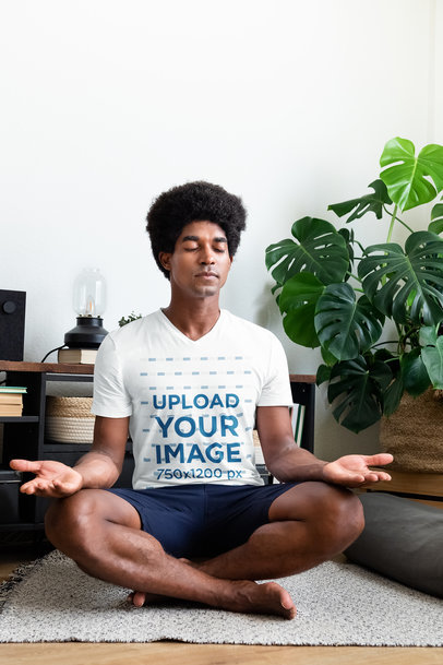 V-Neck Tee Mockup of a Man with an Afro Hairstyle Meditating at Home