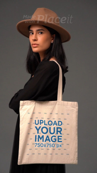 Video of a Serious Woman With a Brown Hat Holding a Tote Bag