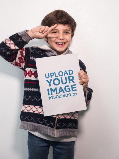 Happy Boy Doing the Peace Sign Holding a Big Book Mockup a19220
