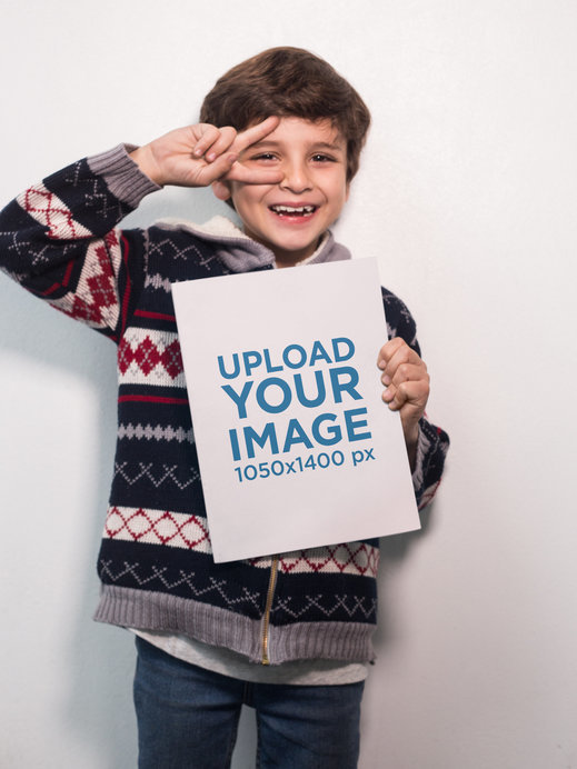 Happy Boy Doing the Peace Sign Holding a Big Book Mockup