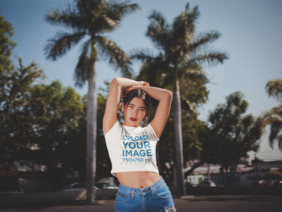 Woman with Arms Up Wearing a Crop Top Tee Mockup on the Street