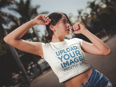 Crop Top Mockup of a Woman Wearing a T-Shirt Dancing on the Street