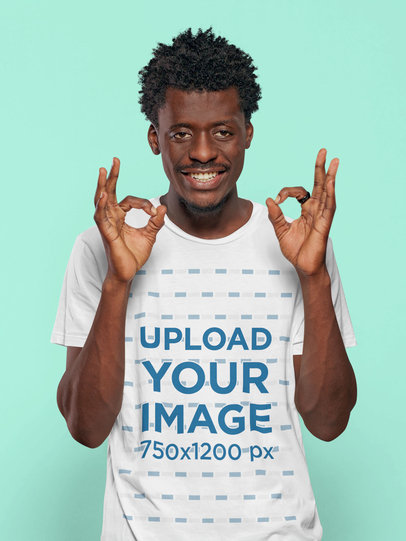 T-Shirt Mockup Featuring an Afro Hairstyle Man Smiling and Showing an Okay Sign