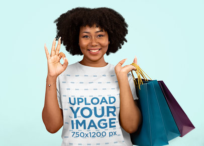 T-Shirt Mockup Featuring a Woman With Afro Hairstyle Carrying Shopping Bags