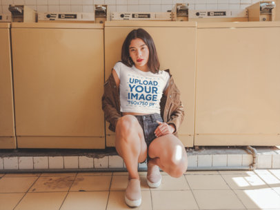 Woman Crouching Wearing a Crop Top Tee Mockup at a Laundry