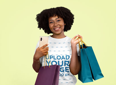 T-Shirt Mockup of a Woman with Afro Hair Carrying Shopping Bags