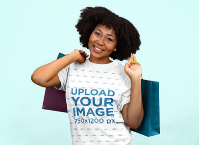 Round-Neck Tee Mockup of a Woman with an Afro Hairstyle Carrying Shopping Bags