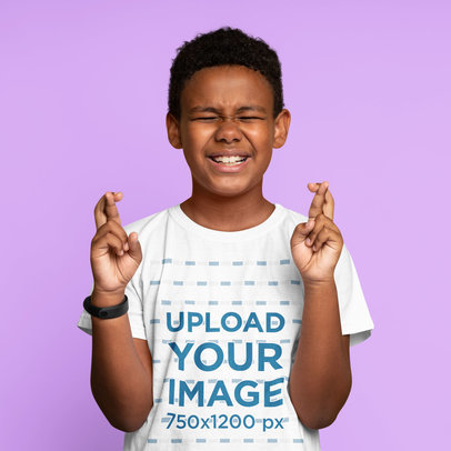 Crewneck T-Shirt Mockup of a Boy Making a Wish with His Fingers Crossed