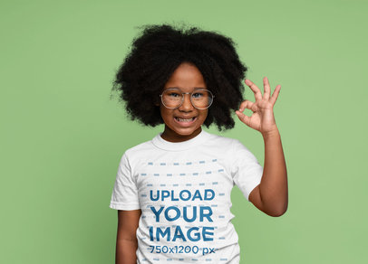 Round-Neck Tee Mockup of a Little Girl with an Afro Hairstyle and Glasses