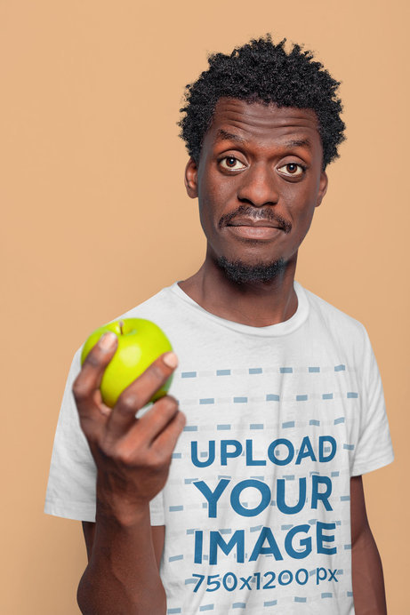 Round-Neck Tee Mockup of a Man Holding an Apple