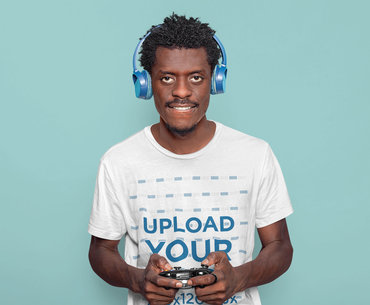 T-Shirt Mockup of a Man with an Afro Hairstyle Playing with a Gaming Controller