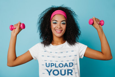 T-Shirt Mockup of a Woman with Curly Hair Doing an Arm Workout with Small Hand Weights