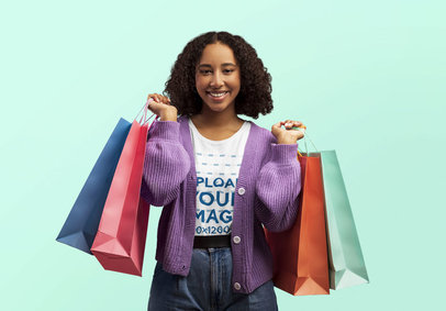 T-Shirt Mockup of a Happy Woman Carrying Shopping Bags