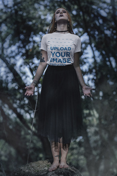 Wicca-Inspired Mockup of a Woman Wearing a Tee and Enjoying Nature