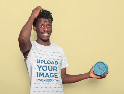 T-Shirt Mockup of a Man With Afro Hairstyle Holding an Alarm Clock