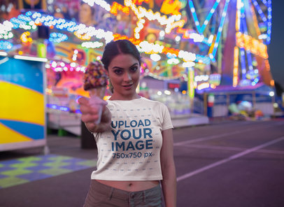 Woman Handing an Ice Cream Wearing a Crop Top Tee Mockup at an Amusement Park